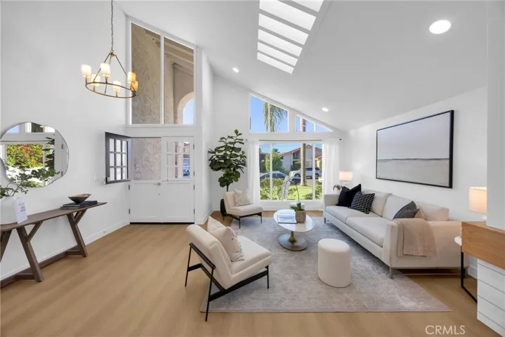 Living room with vaulted ceilings and skylights
