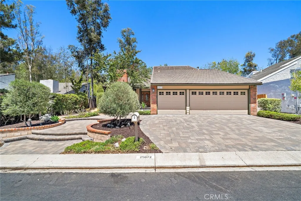 Custom landscaping and driveway with custom pavers for 3-car side by side parking.