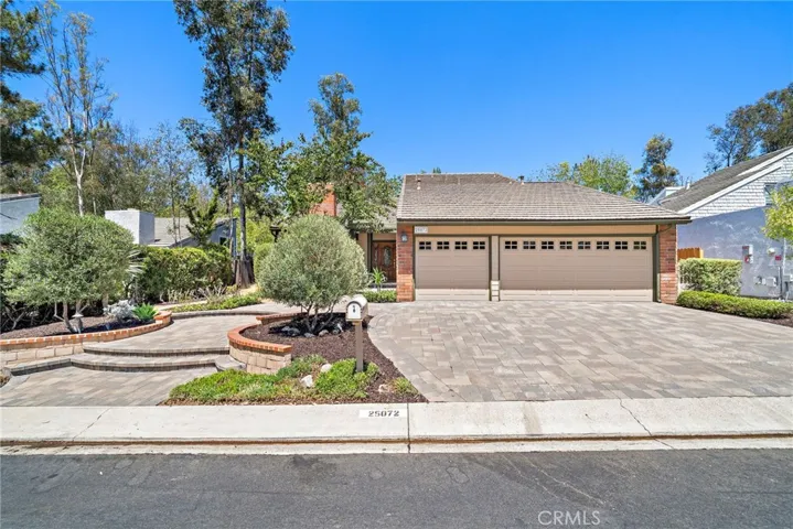 Custom landscaping and driveway with custom pavers for 3-car side by side parking.