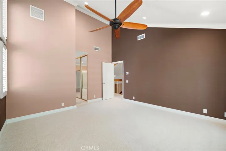 Primary bedroom suite is a welcomed retreat and opens from the balcony to the tranquil landscape.