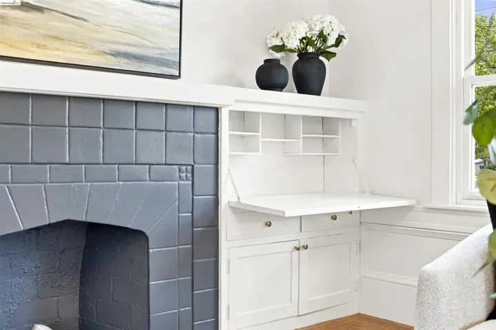 Fireplace with grey tile surround and hearth