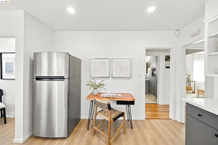 Stainless steel refrigerator set against light-toned wood-finish flooring