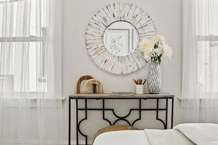 Light-filled interior featuring a console table with a decorative metal base and a wood-finish top