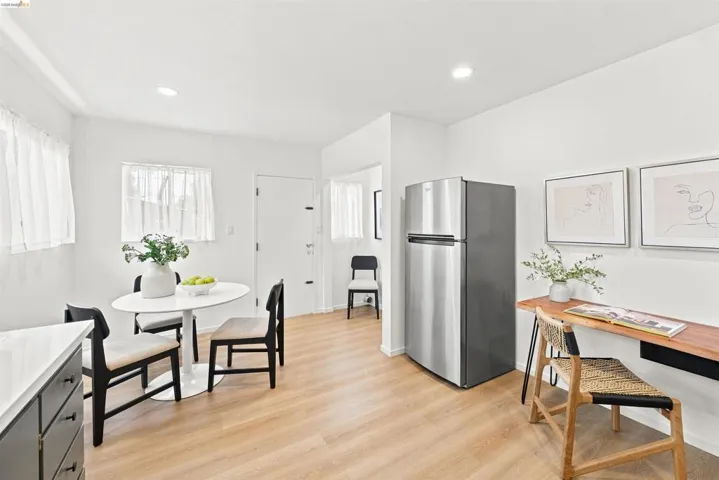 Open-concept living space featuring wood-finish flooring, recessed lighting, and a neutral color palette