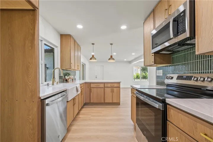Updated Kitchen - Rich wood cabinetry offers timeless style and storage
