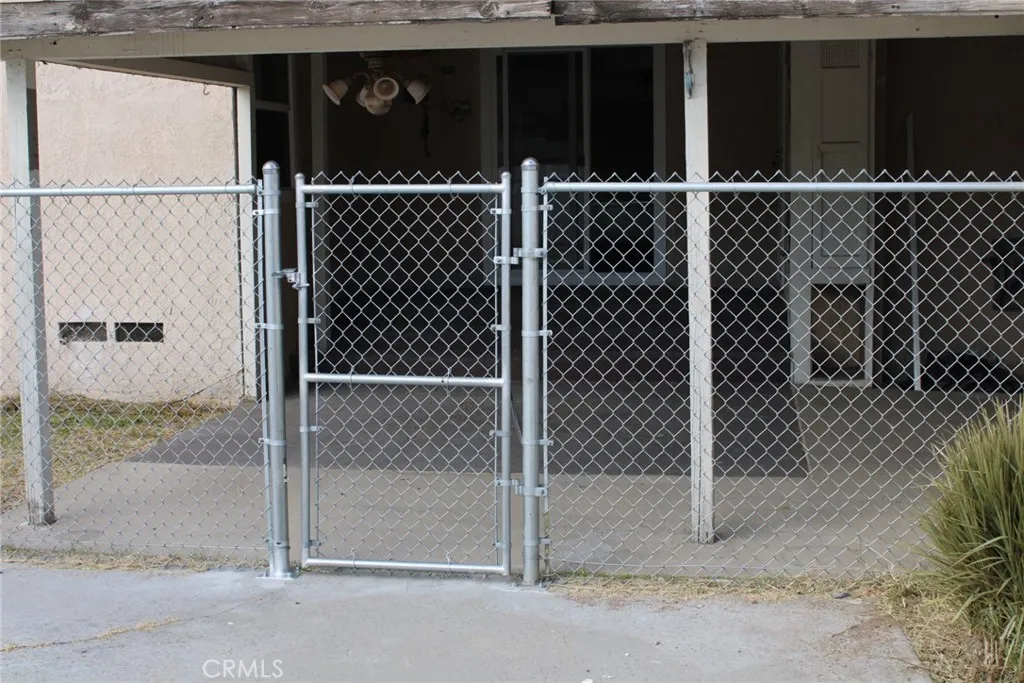 Outside patio enclosure and fence leading to pool Outside patio enclosure and fence leading to pool