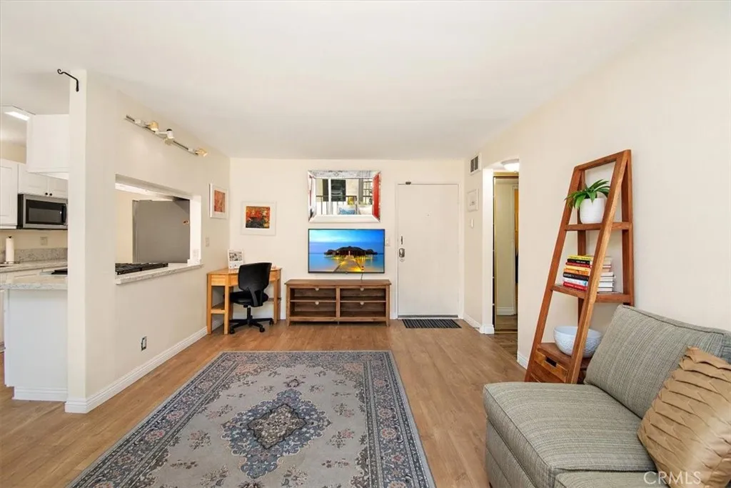 Open floor plan kitchen, dining, balcony, living room