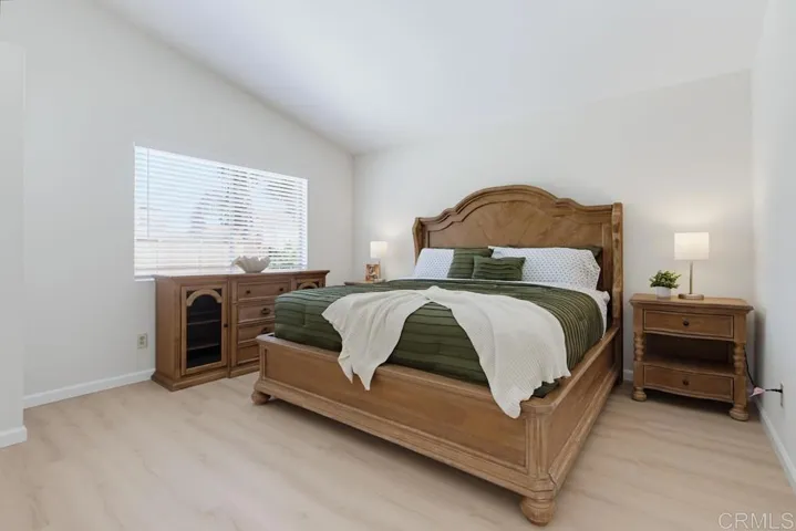 Primary bedroom overlooks sparkling pool