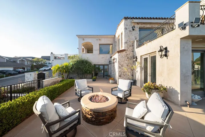Inviting fire-pit seating area, one of several outdoor gathering spaces designed for year-round relaxation and entertaining.