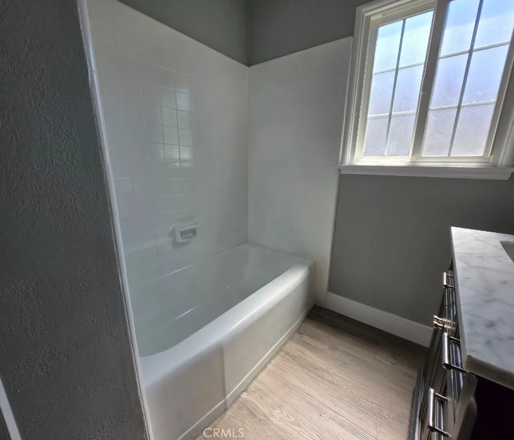 Fresh guest bath feels brand new, featuring a crisp finish and modern vanity with quartz counter