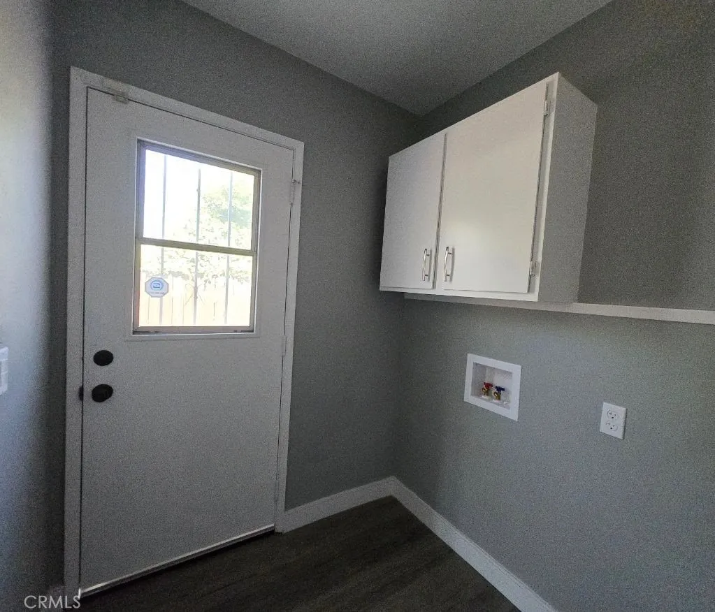 Laundry room conveniently located off the kitchen with quick access to the side yard