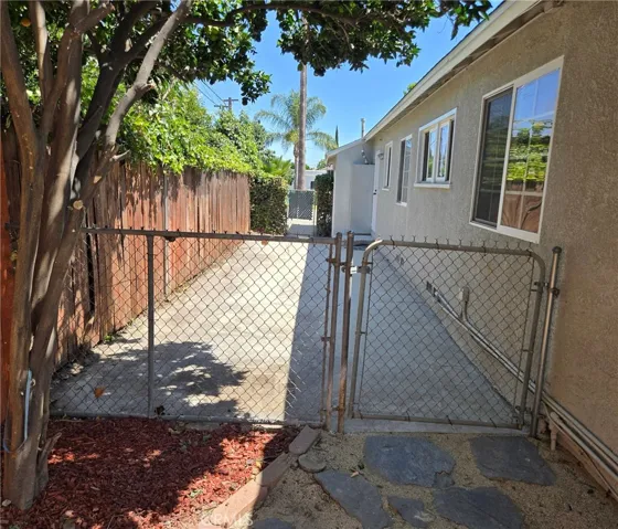 Gated side yard offers secure yet flexible options for separating spaces or open use