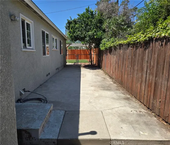 Versatile side yard well suited for pets, storage or a variety of other uses.
