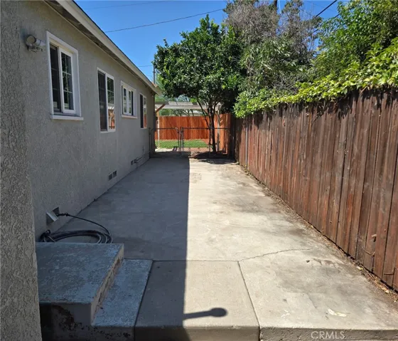 Versatile side yard well suited for pets, storage or a variety of other uses.