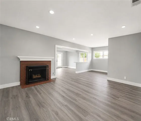 Ample living room is anchored by a charming fireplace