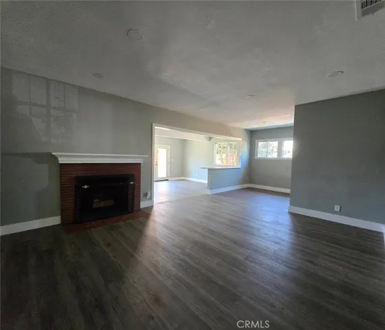 Ample living room is anchored by a charming fireplace