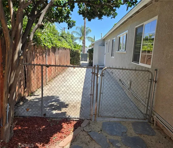 Gated side yard offers secure yet flexible options for separating spaces or open use