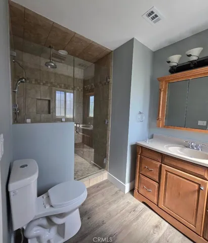 Ensuite bath featuring an oversized glass-enclosed shower