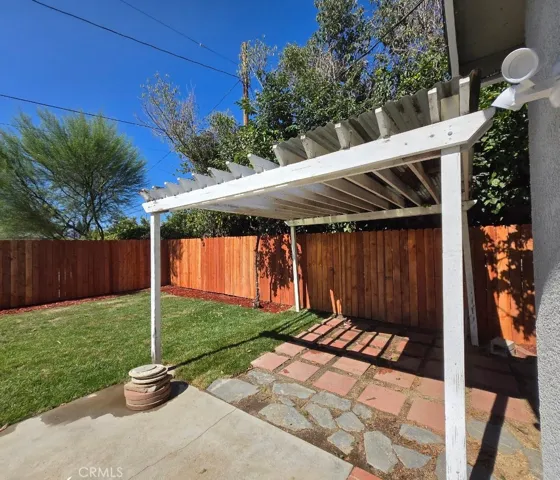 Charming pergola offers a welcoming setting for outdoor relaxation and entertaining