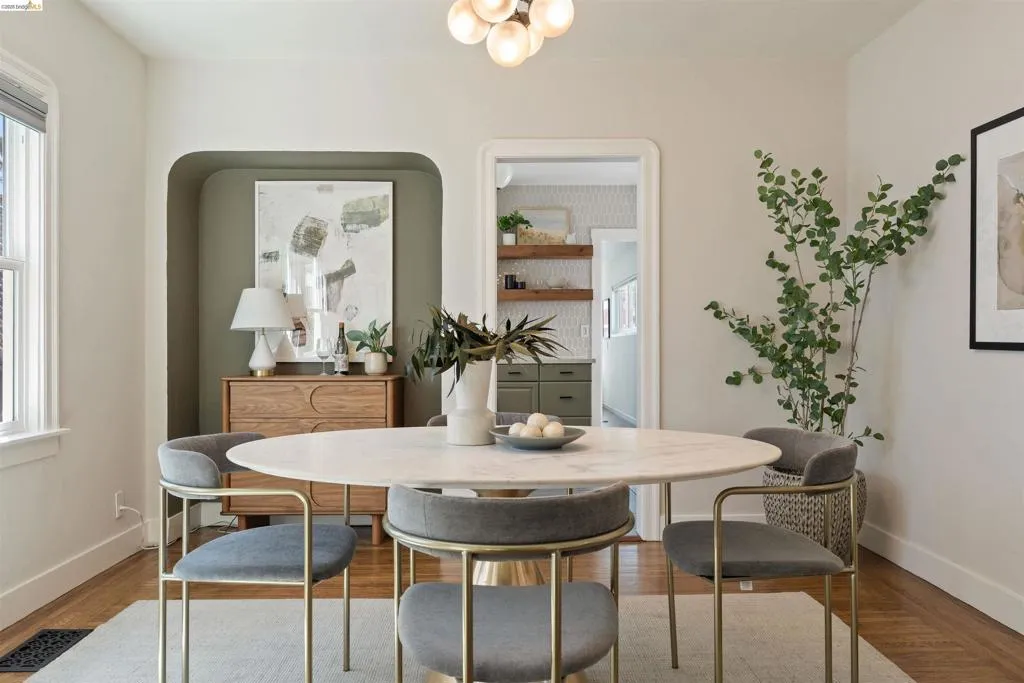 Dining area featuring a contemporary globe chandelier and wood-finish flooring