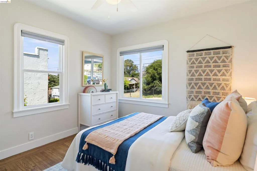 Front bedroom has hardwood floor and ceiling fan.