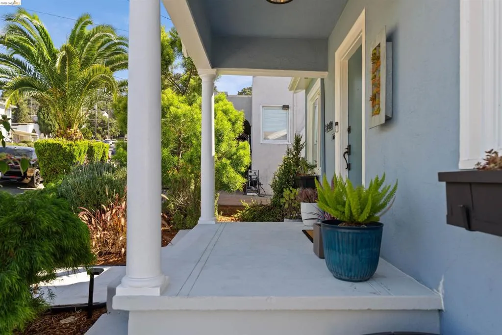 Covered front porch featuring white columns