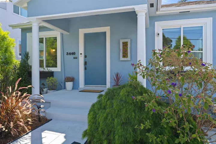 Exterior facade featuring a blue finish, white trim, and a covered entryway