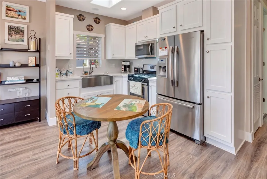 Kitchen features high ceiling and skylight.