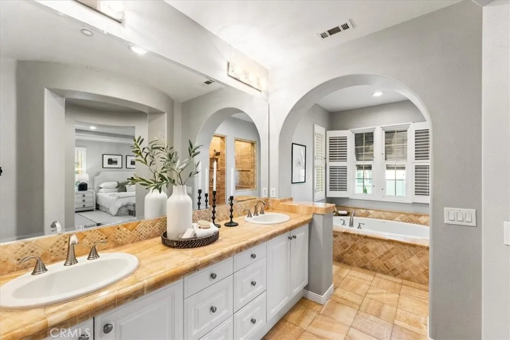 Primary Bathroom with dual sinks, spa tub and separate shower