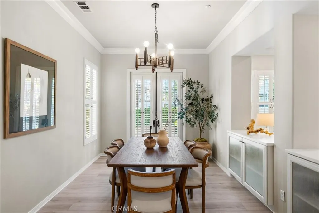 Separate dining room with French doors opening to courtyard