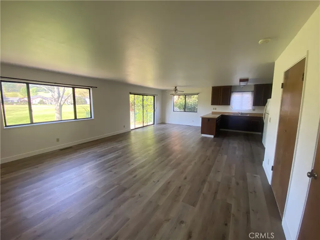 Large open great room with lots of windows.
