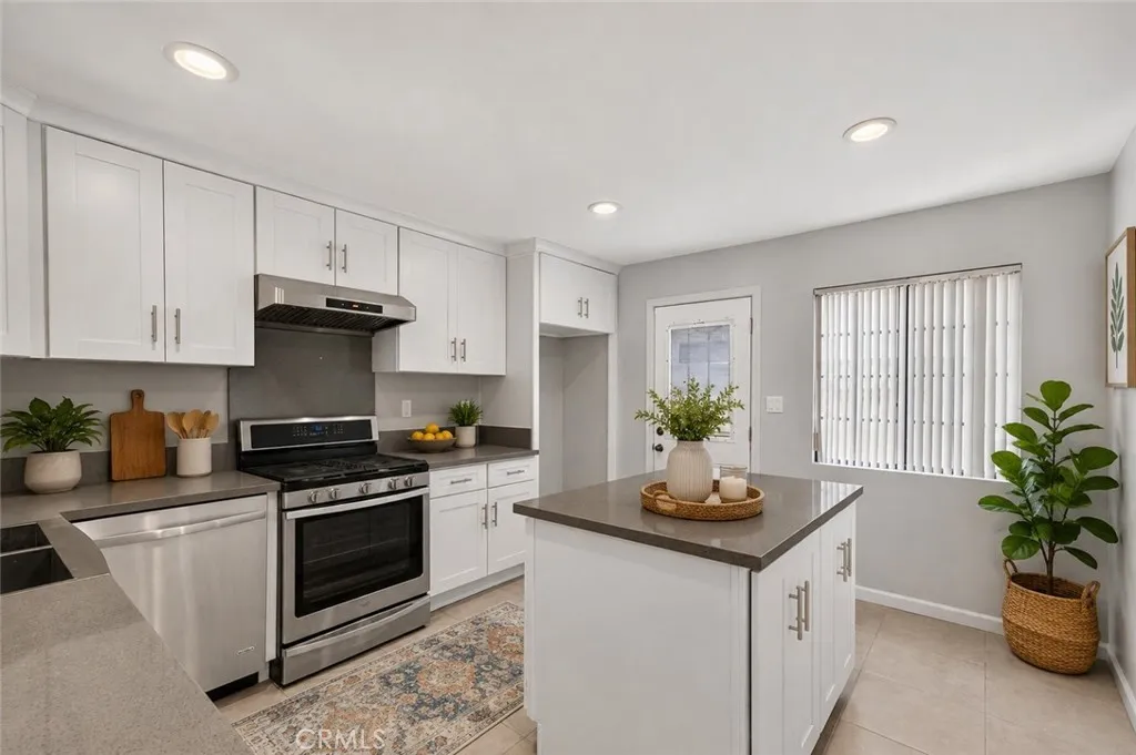 Kitchen with stainless steel appliances and generous counter space.