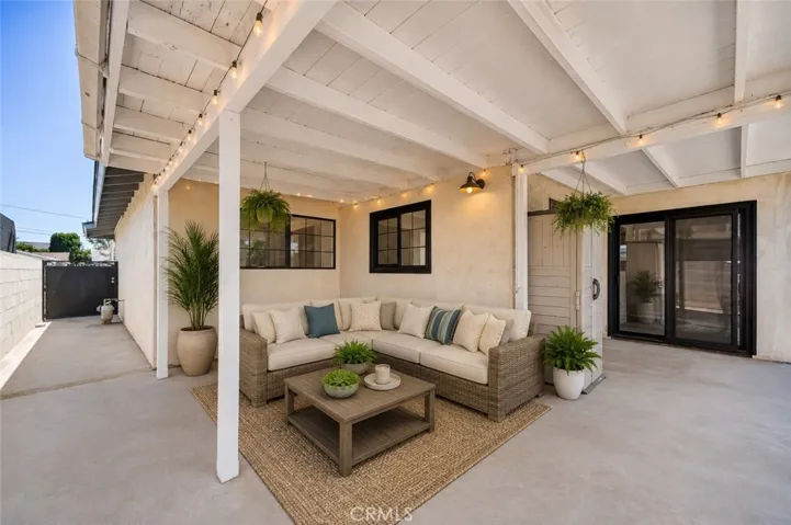 Covered patio extends comfortable indoor-outdoor living space.