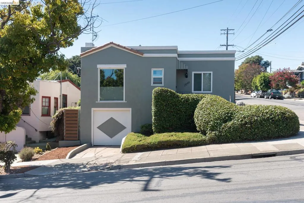 Stucco exterior with a terracotta-style roof accent