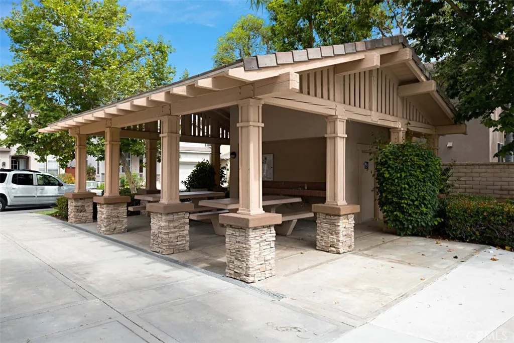 Community Pavilion: Covered picnic pavilion with built-in seating and stone-accented columns provides a shaded gathering area.