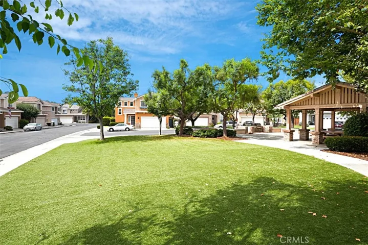 Community Green Space: Open lawn area with mature shade trees and a covered pavilion for outdoor use.