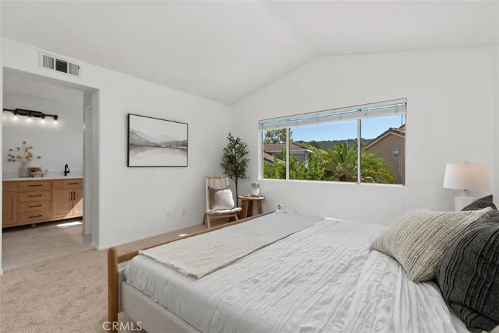 Primary Bedroom: An alternate view highlights the large window, open feel, and direct connection to the ensuite bath.
