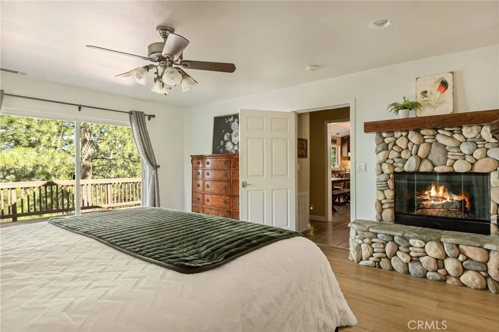 Main level primary bedroom with fireplace.