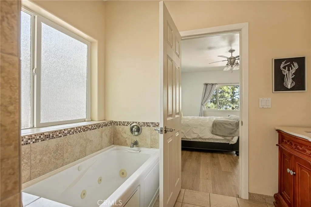 2nd floor primary bedroom with soaker tub and walk in shower.