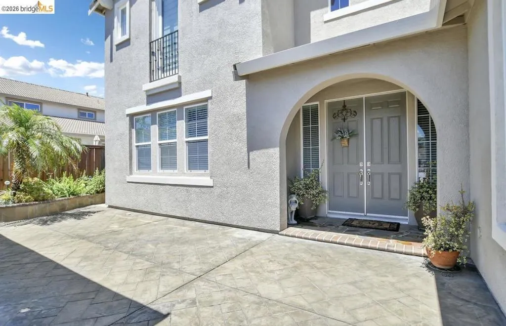 Arched entryway featuring double paneled doors and sidelight windows