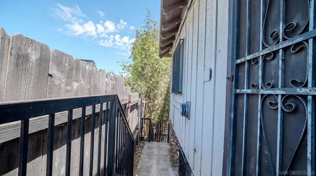 Side yard leading downstairs to back yard
