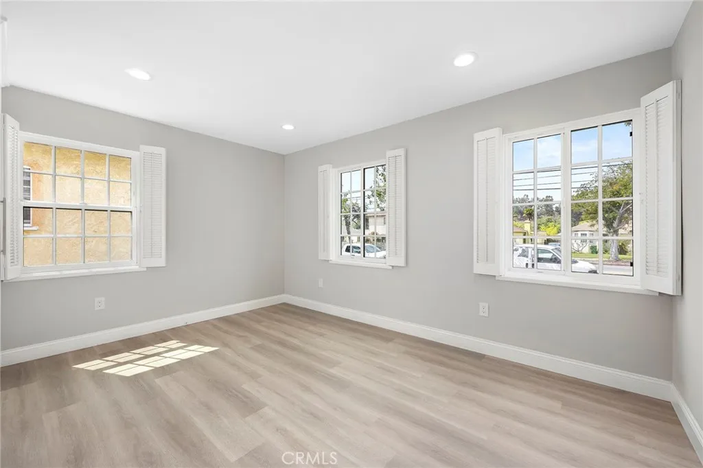 Light and bright bedroom one with three windows, newly remodeled.