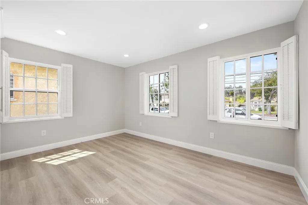 Light and bright bedroom one with three windows, newly remodeled.