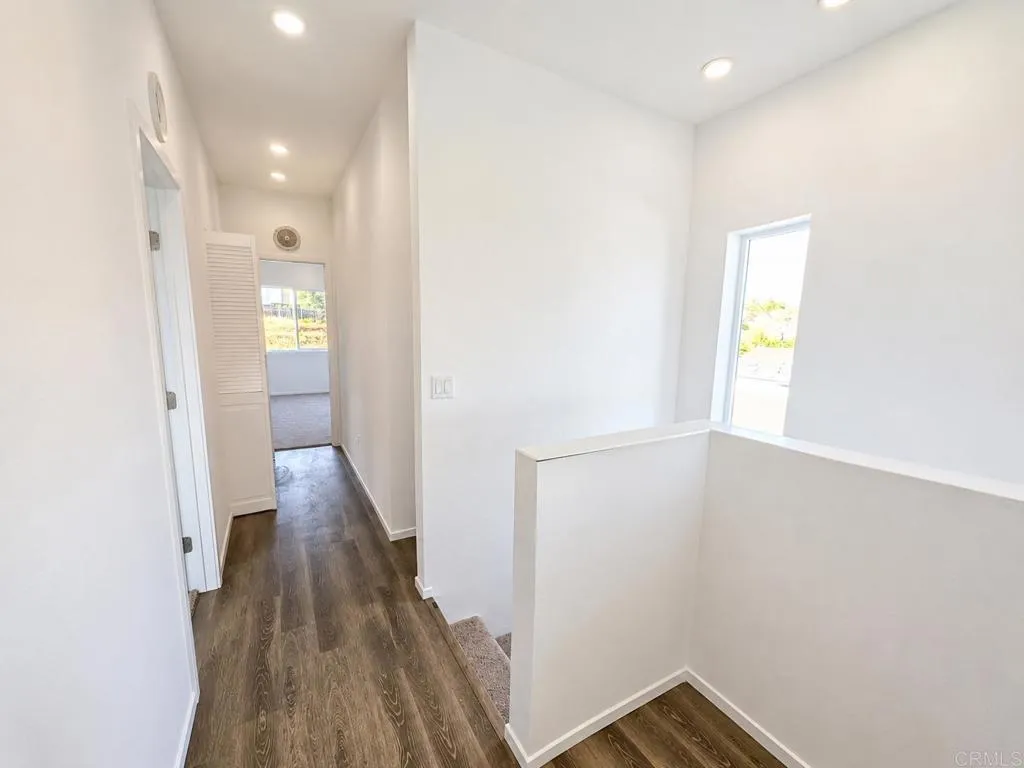 Hallway leading to the bedrooms and the laundry closet.