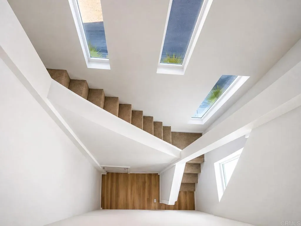 Open stairwell enhances the home's bright and airy design.