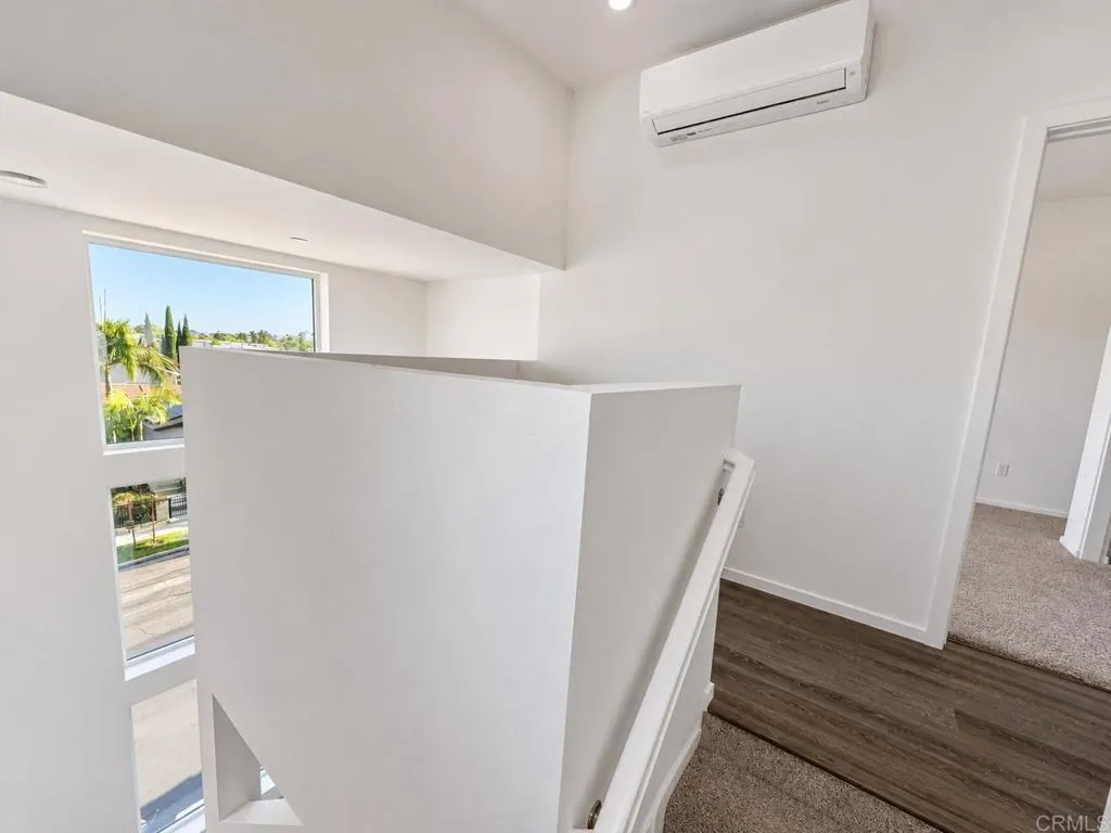 Open landing connecting the home's third-level living spaces.