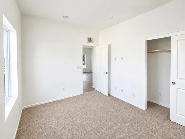 Bright secondary bedroom with a spacious layout and abundant natural light.