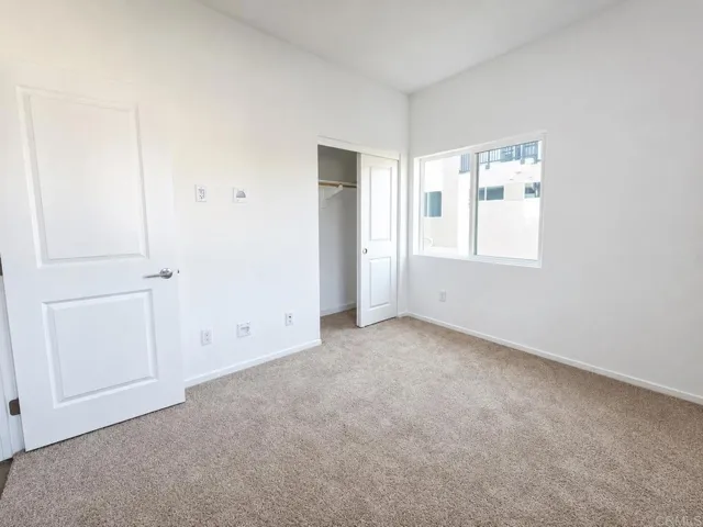 Alternate view showcasing the bedroom's generous size and natural light.