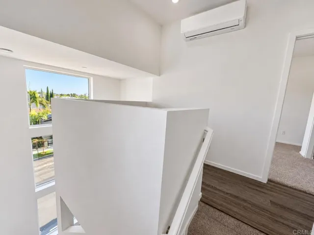 Open landing connecting the home's third-level living spaces.