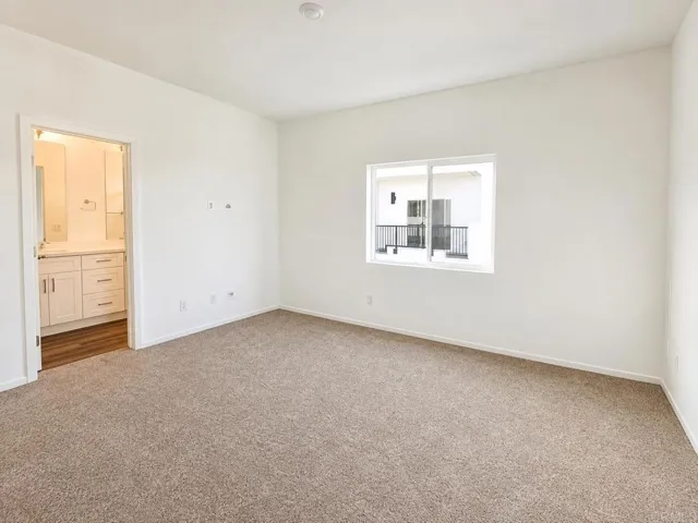 Spacious primary suite with large windows and a relaxing atmosphere.